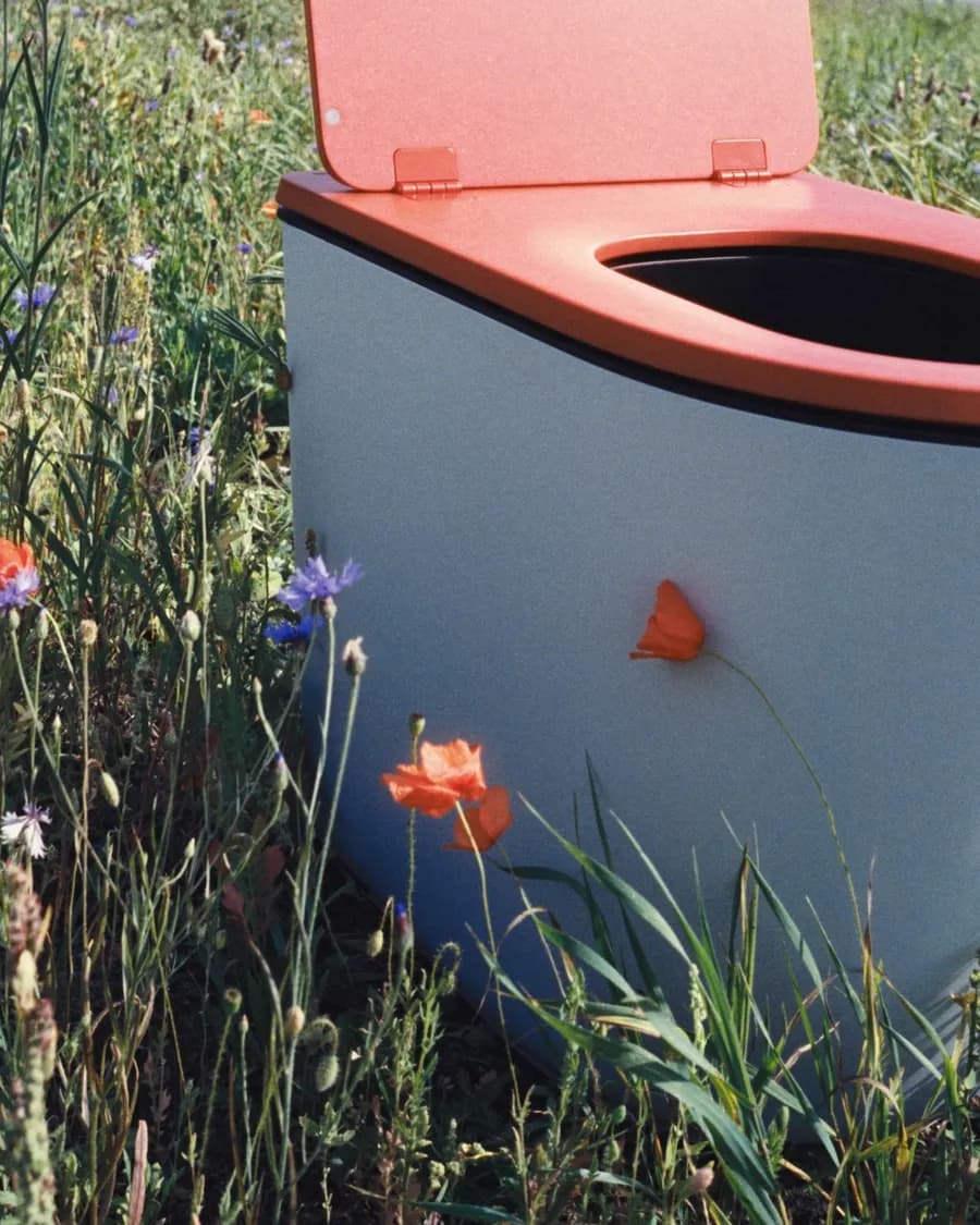 Light blue Luna with terracotta seat in a flowering meadow with poppies and cornflowers